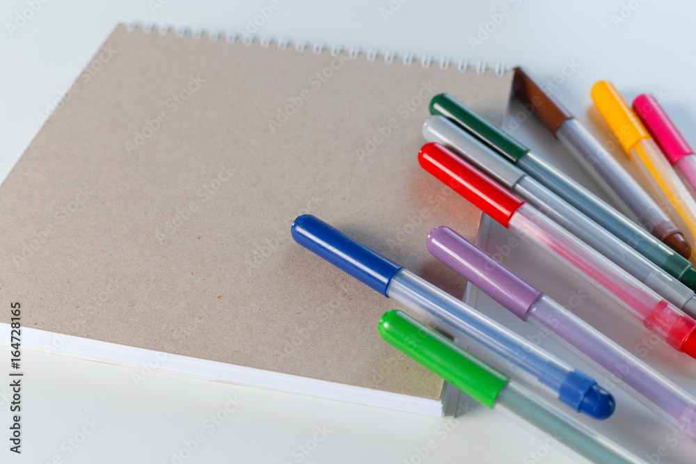Color pencil and sketchbook on a table Color pencil and sketchbook on a table