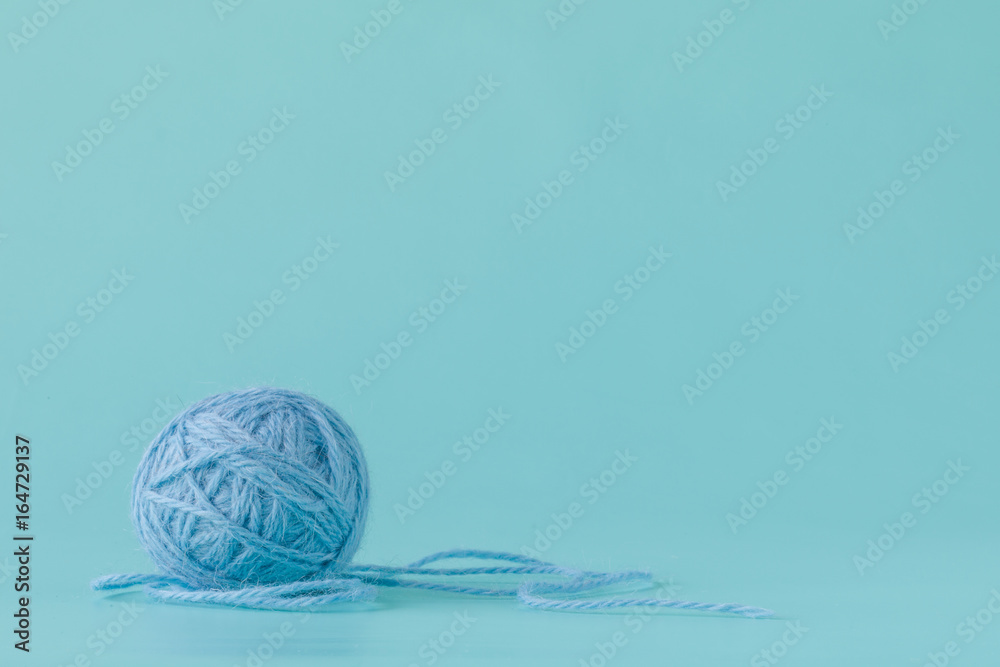 Ball of yarn on aquamarine background Ball of yarn on aquamarine background