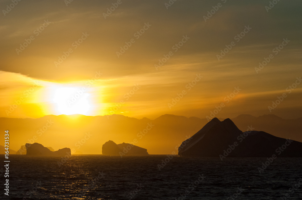 Icebergs in Antarctica at sunset