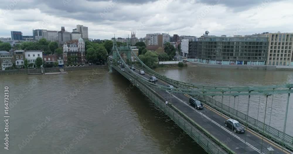 Aerial ascending view of Hammersmith bridge and the river Thames in West London Aerial ascending view of Hammersmith bridge and the river Thames in West London