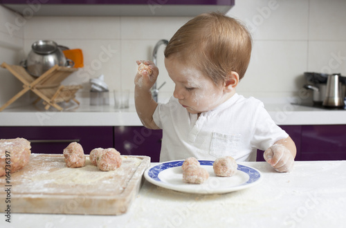 Baby boy preparing meatballs