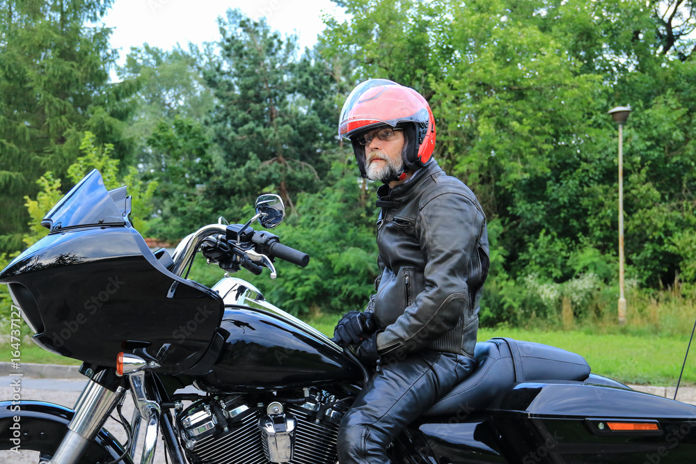 Man in a red helmet on the black motorcycle Man in a red helmet on the black motorcycle