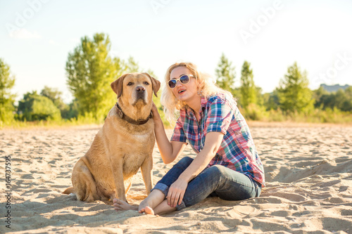Young woman with her dog at the beach