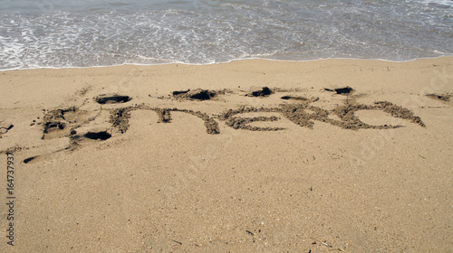 Merci écrit une plage de sable fin