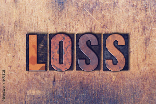 Loss Theme Letterpress Word on Wood Background photo