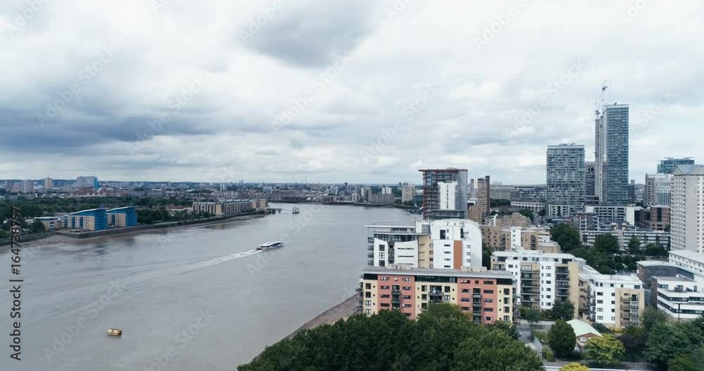 Aerial ascending view of the river Thames by the financial district of the docklands in London Aerial ascending view of the river Thames by the financial district of the docklands in London