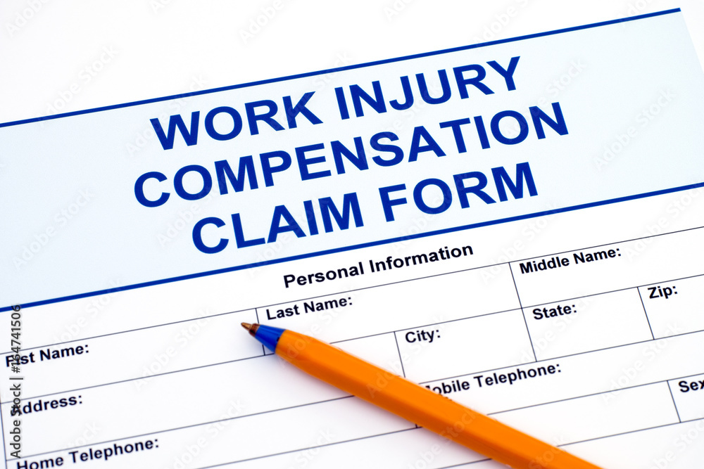 Work Injury Compensation Claim Form with pen Work Injury Compensation Claim Form with pen