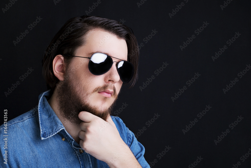 Fototapeta premium Studio portrait of caucasian young man standing up on black background