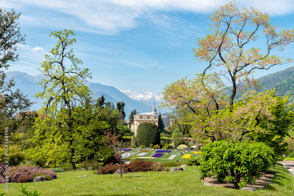 Landscape of Botanical Gardens of Villa Taranto with colorful flowers and palms, located on the shore of Lake Maggiore in Pallanza, Verbania, Italy.