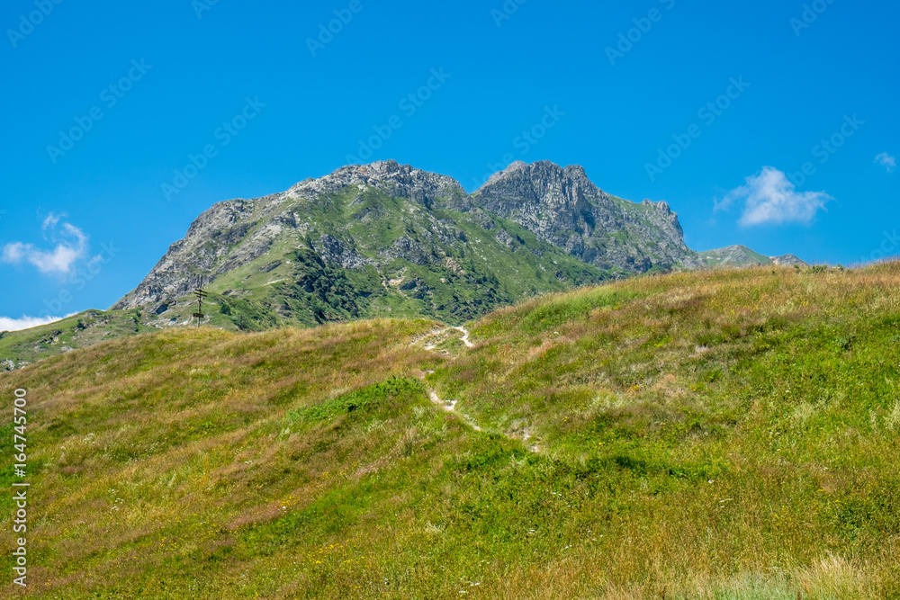 Mountain peaks and meadows in Grana Valley, Cuneo, Piedmont, Italy.