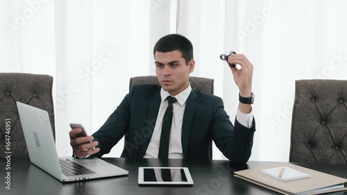 Businessman with a spinner, confident director with spinner fidget, business man with laptop and tablet in modern office relax with spinner toy photo