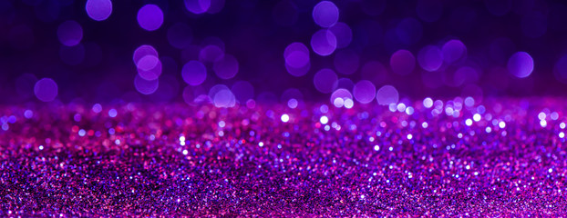 purple Sparkling Lights Festive background with texture. Abstract Christmas twinkled bright bokeh defocused and Falling stars. Winter Card or invitation.