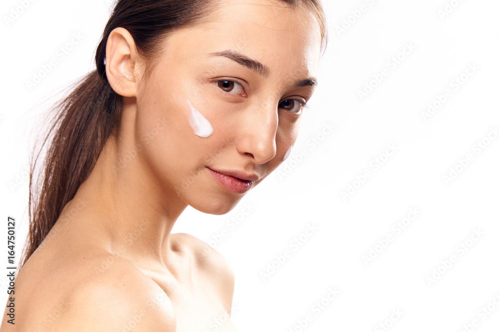 Young beautiful woman on white isolated background, portrait, cosmetic cream Young beautiful woman on white isolated background, portrait, cosmetic cream
