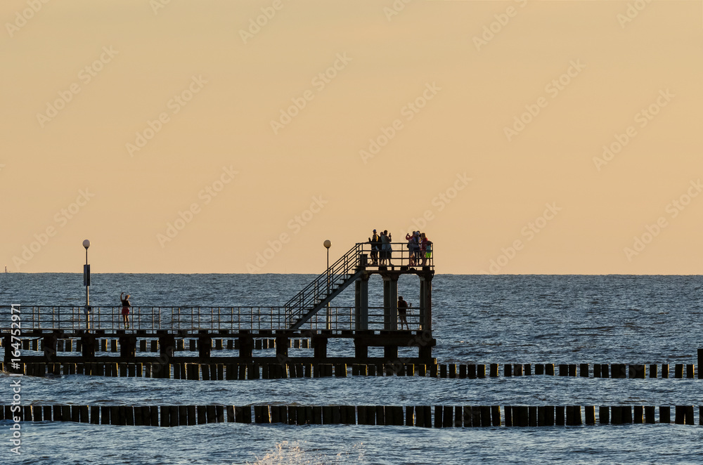 BEACH HOLIDAY AND SELFIE- Small coastal pier at sunset