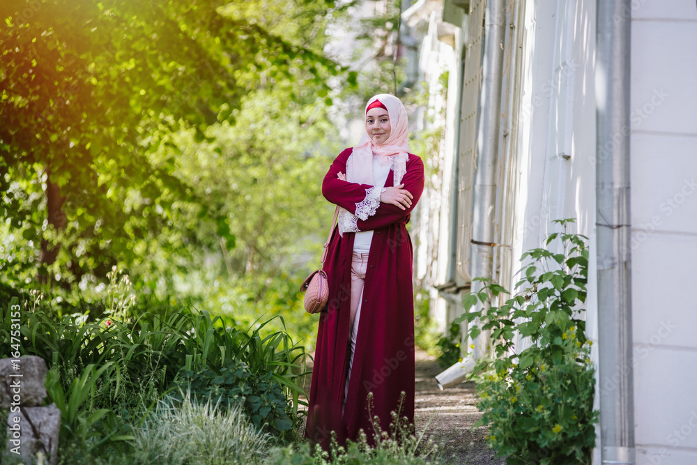 young muslim woman in head scarf using phone young muslim woman in head scarf using phone