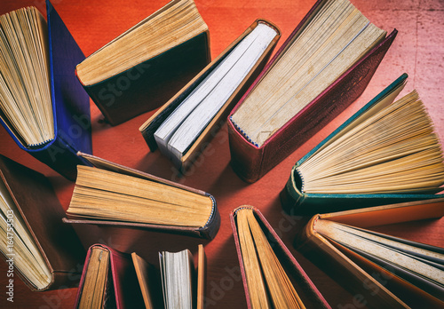 Vintage books on wooden background - top view