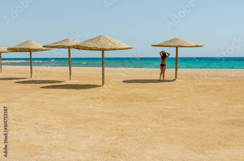 Fototapeta Naklejka Na Ścianę i Meble -  One girl on a deserted beach