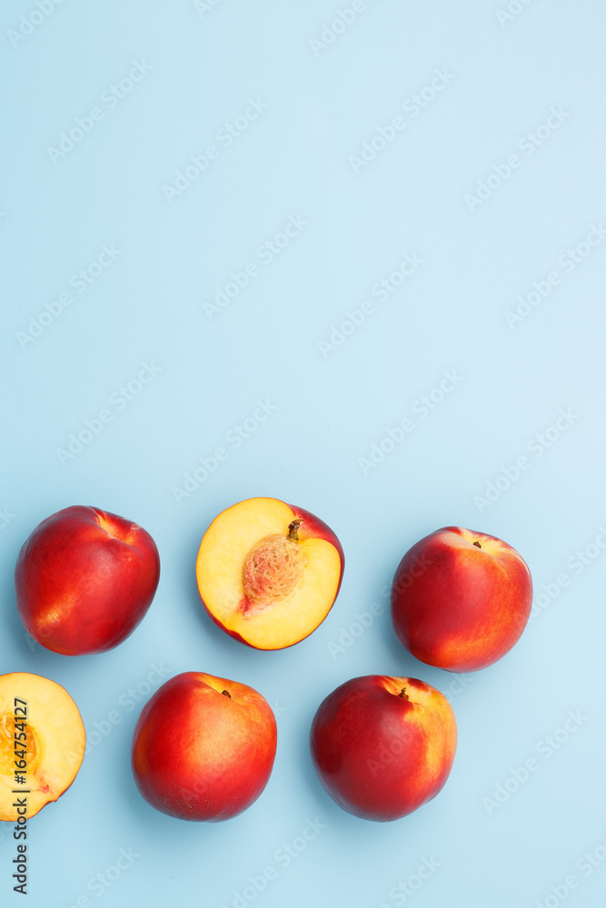 A few ripe nectarines on a blue background A few ripe nectarines on a blue background