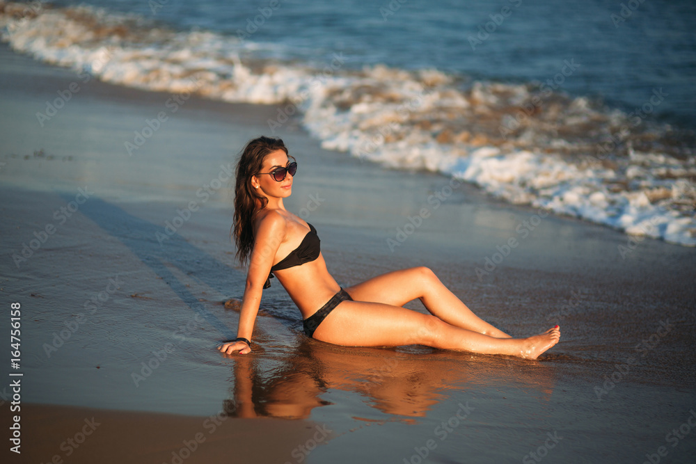 Beautiful girl sunbathing on a sandy beach. sunset silhouette
Beautiful girl sunbathing on a sandy beach. sunset silhouette
