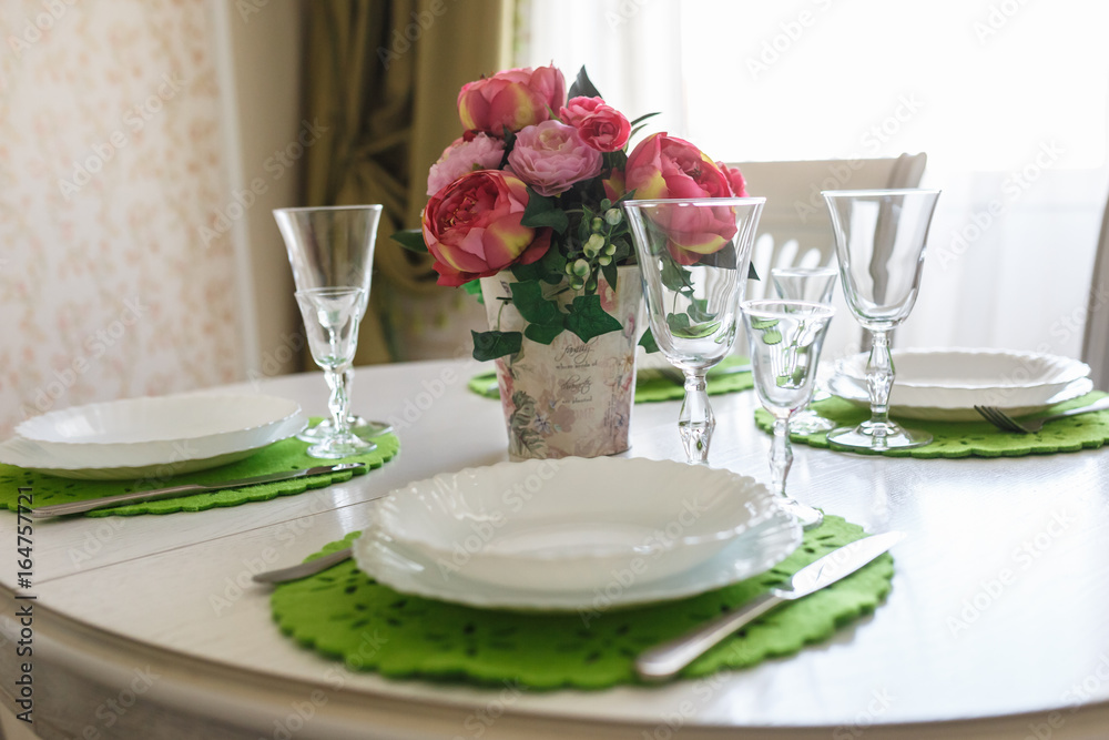 Bouquet of pink peonies flowers on a table with cutlery Bouquet of pink peonies flowers on a table with cutlery