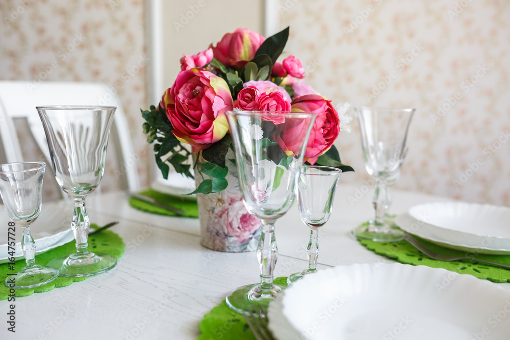 Bouquet of pink peonies flowers on a table with cutlery Bouquet of pink peonies flowers on a table with cutlery