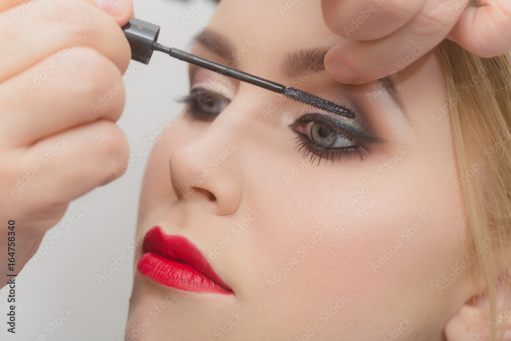 fashion model girl getting mascara on eyelashes
