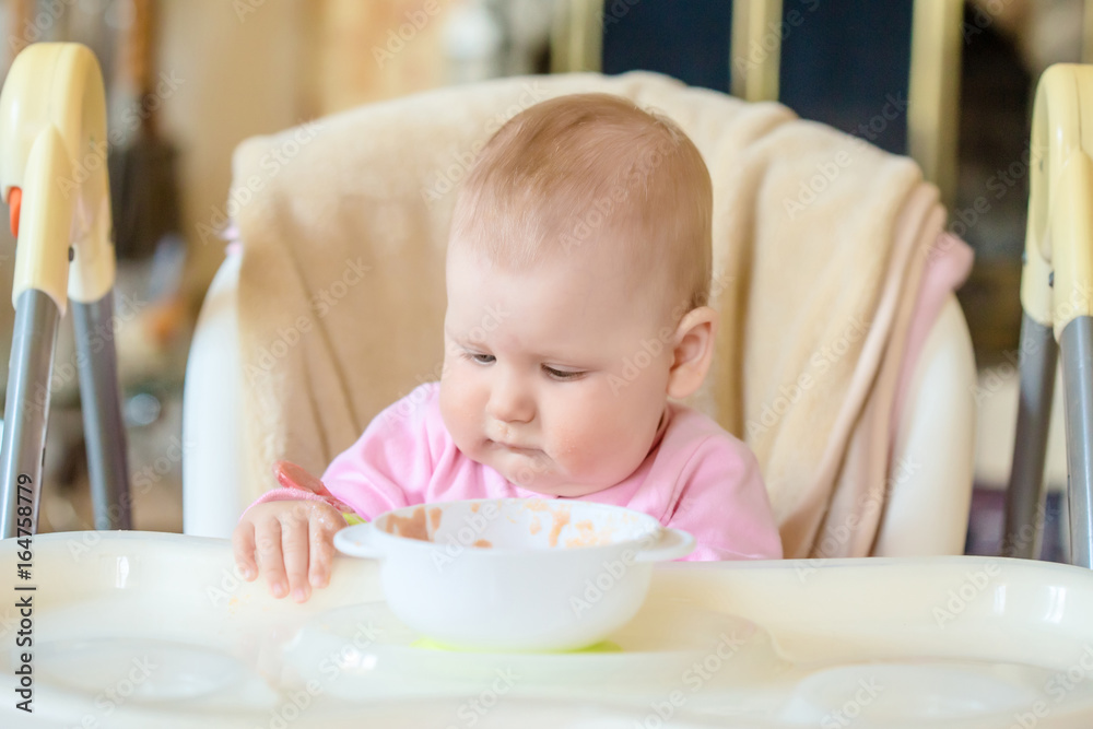A cheerful happy child eats porridge. A cheerful happy child eats porridge.
