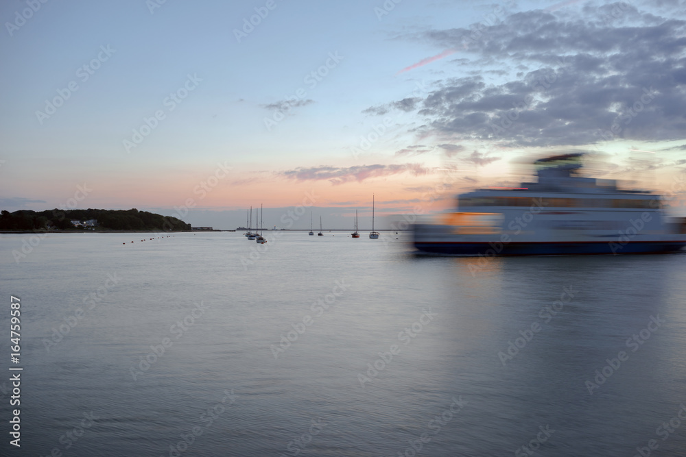 A twilight capture of Yarmouth Harbour on the Isle of Wight at dusk.A ferry is departing the harbour.