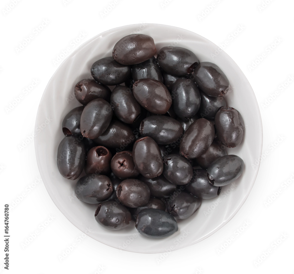 Black pitted olives in bowl isolated on white background, top view, close up. Black pitted olives in bowl isolated on white background, top view, close up.