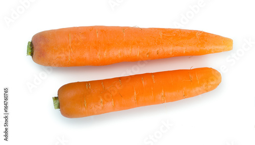Pair of fresh, ripe carrots isolated on white background, top view.