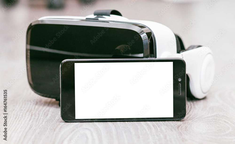 VR Glasses or Virtual Reality Headset helmet with phone wood background VR Glasses or Virtual Reality Headset helmet with phone wood background