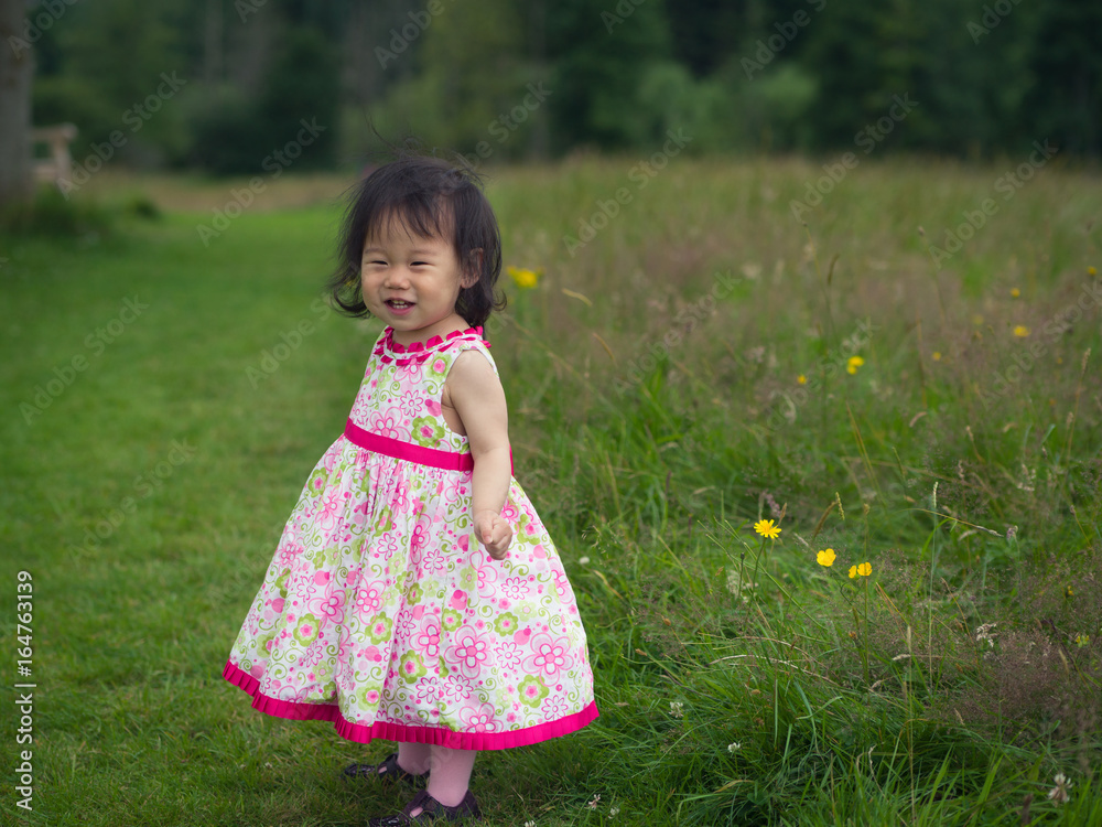 baby girl playing in summer garden baby girl playing in summer garden