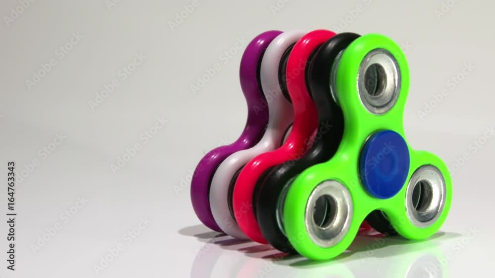 Several multi-colored spinners on the table Several multi-colored spinners on the table