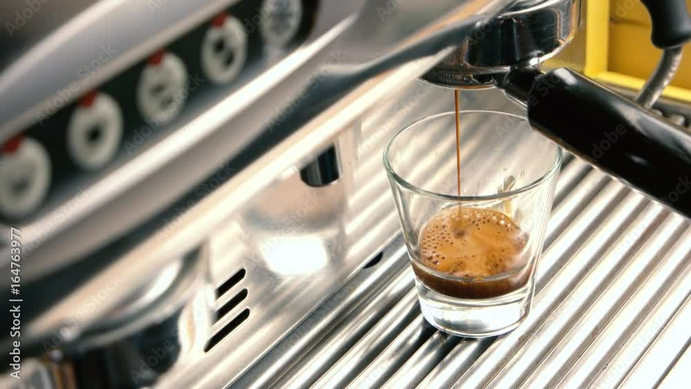 Espresso machine and shot glass. Fresh coffee with foam. Espresso machine and shot glass. Fresh coffee with foam.