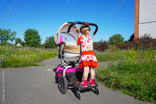 Universal baby stand for a second child, stand-on board for child carriages, designed to fit any stroller or pram. photo