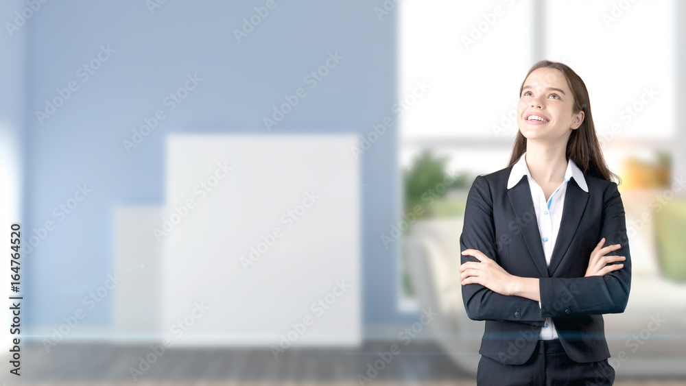 Young beautiful business woman and creative designer standing over blured interior background Young beautiful business woman and creative designer standing over blured interior background