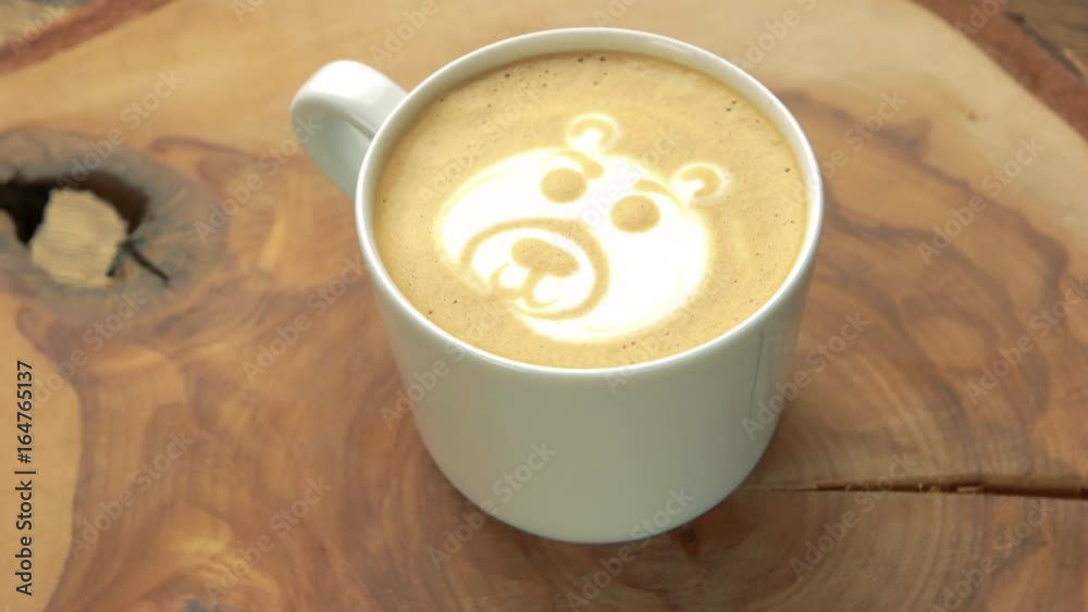 Bear coffee foam art. White cup with latte. Bear coffee foam art. White cup with latte.