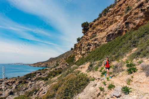 Man running in inspirational mountains and seaside