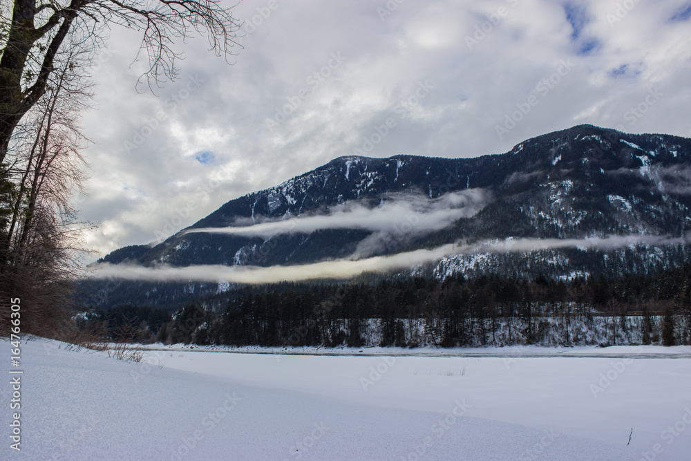 low hanging clouds and overcast during the winter over the Fraser River, Hope British Columbia, Canada