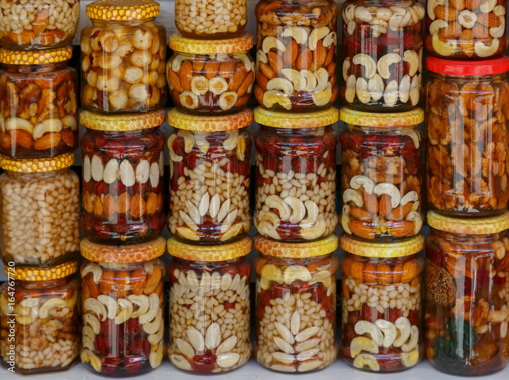Beautifully decorated jars with honey and nuts as traditional souvenir