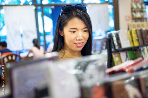 Asian girl buying a compact disc