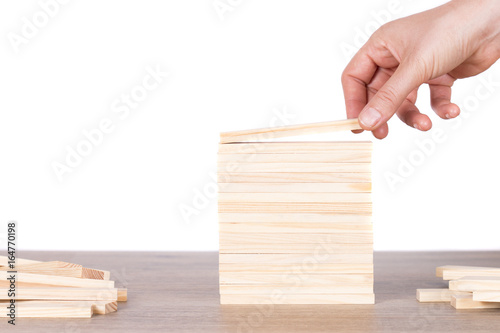 women hand putting block on top