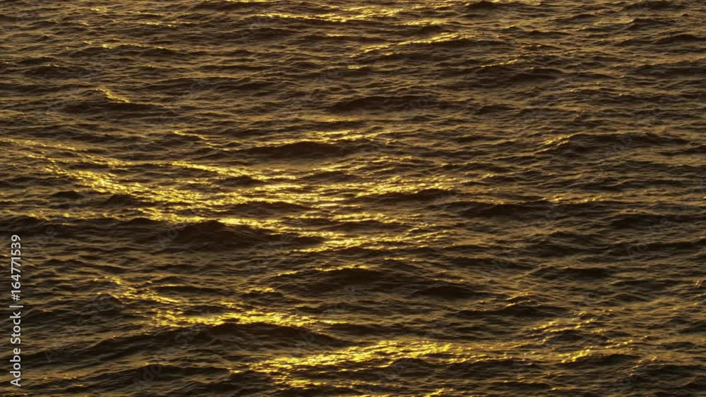Wide panning shot of ocean waves at sunset / St. Georges, Greneda Wide panning shot of ocean waves at sunset / St. Georges, Greneda