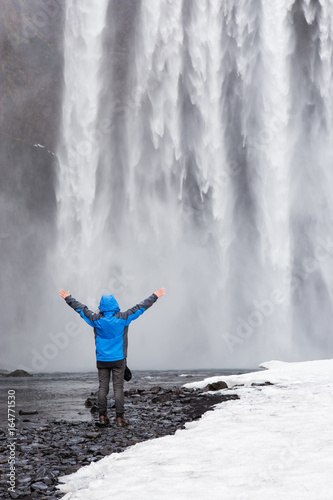 One man posing at Skogafoss waterfall in Iceland