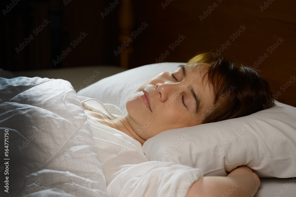 Young beautiful woman sleeping in her bed at night Young beautiful woman sleeping in her bed at night