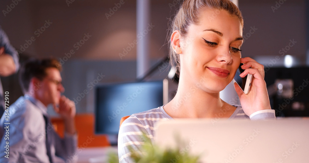 woman using mobile phone in dark office