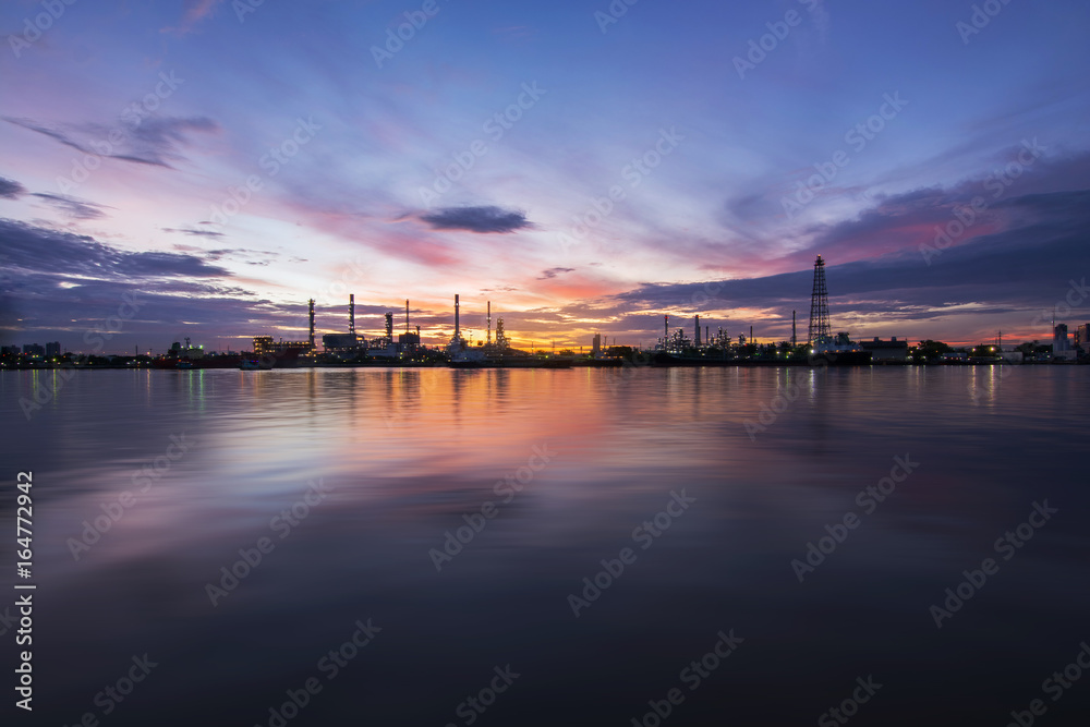 Oil refinery or petrochemical industry with ship at Sunset with water reflection in thailand. for Logistic Import Export background, Petroleum, petrochemical plant.