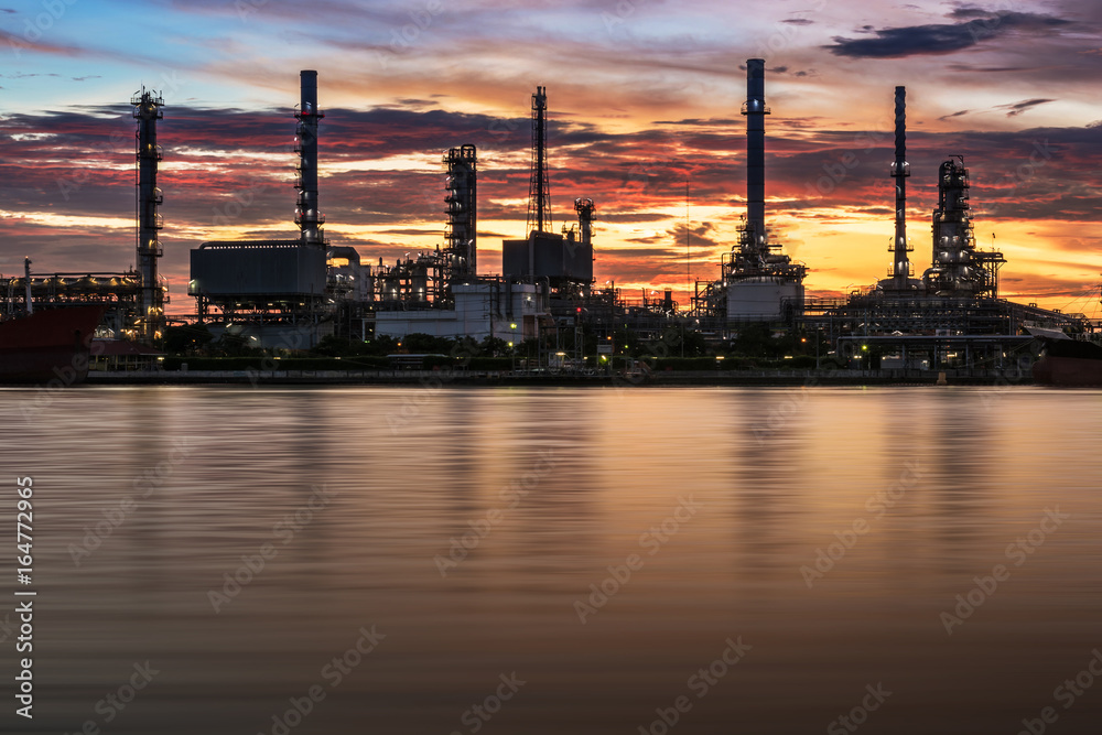 Oil refinery or petrochemical industry with ship at Sunset with water reflection in thailand. for Logistic Import Export background, Petroleum, petrochemical plant.