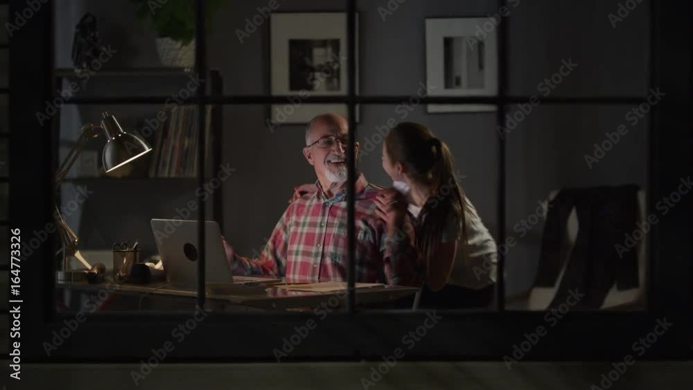 Medium zoom in shot of girl surprising grandfather with hug / Cedar Hills, Utah, United States Medium zoom in shot of girl surprising grandfather with hug / Cedar Hills, Utah, United States