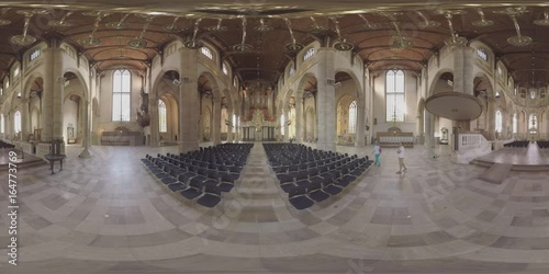 ROTTERDAM, NETHERLANDS - AUGUST 07, 2016: 360 VR video. Interior of medieval St. Lawrence Church built between 1449 and 1525. View to the hall with empty chairs, pipe organ and grand columns. Man photo